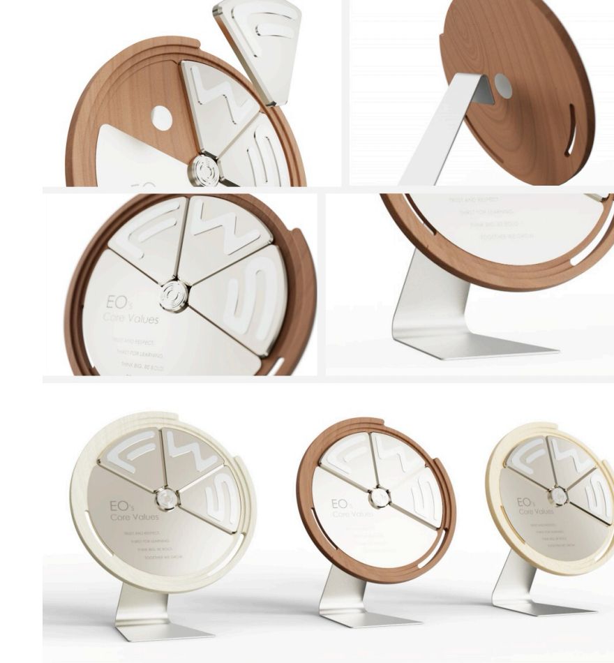 Round trophies in walnut and white on brushed metal stands