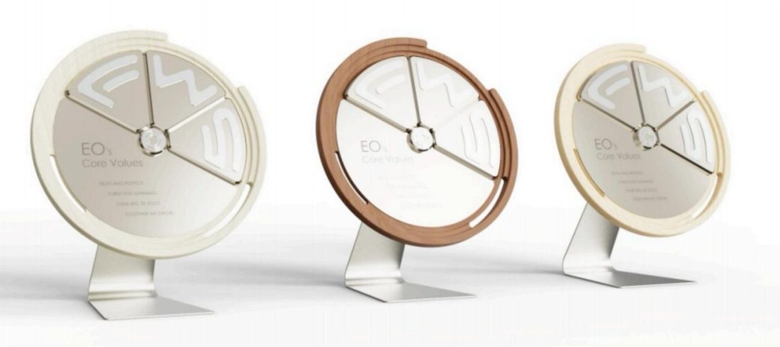 The award in three finishes, from light wood to walnut.