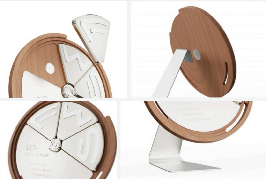 Construction: segmented face, wood-grain ring and the bent alloy stand.